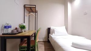 a room with a bed and a table with a bed gmaxwell gmaxwell gmaxwell at Swing and Pillows - Jalan Changkat Thambi Dollah in Kuala Lumpur