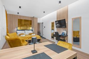 a hotel room with a bed and a table and chairs at Apartmani Point Pregrada in Pregrada