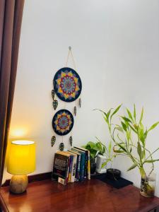 a table with a lamp and plates on a wall at 1bhk in Calangute North Goa nearby beach Sea Breeze Bay in Calangute
