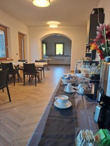 a table with cups and saucers on it in a room at Vie D'Alt Wine and Rooms  +5 photos