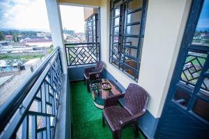 un balcone con due sedie e un tavolo di Most Executive house in Naka Lakeview & central a Nakuru