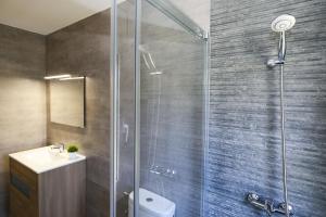 a bathroom with a shower with a toilet and a sink at Villa ADELFA in Salou +20 photos