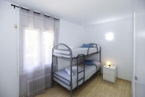 a bedroom with two bunk beds and a window at Villa ADELFA in Salou