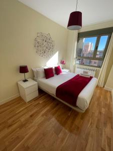 a bedroom with a large bed and a large window at Cituspace Las Tablas Azofra in Madrid