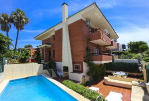 a house with a swimming pool in front of it at Villa COCOCHA in Salou
