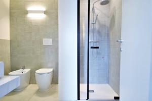 a bathroom with a shower and a toilet and a sink at Venice Terminal Apartments & Suites in Mestre