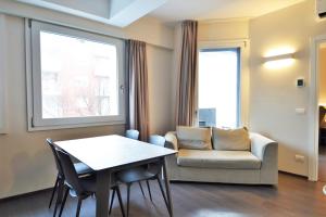 a living room with a table and a chair and a couch at Venice Terminal Apartments & Suites in Mestre