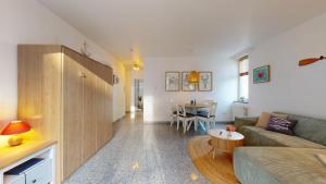 a living room with a couch and a table at strandnahe FeWo mit Schwimmbad im Haus, a cappella 68,Binz in Binz