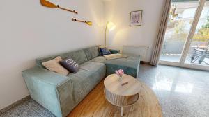 a living room with a couch and a table at strandnahe FeWo mit Schwimmbad im Haus, a cappella 68,Binz in Binz +20 photos