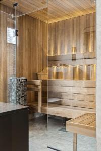 a sauna with wooden walls and a glass door at Fjordview Arctic Lodge with sauna and Jacuzzi in Lyngværet