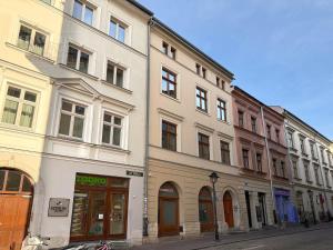 a large white building on a city street at Art Palace - Fragola Apartments in Kraków