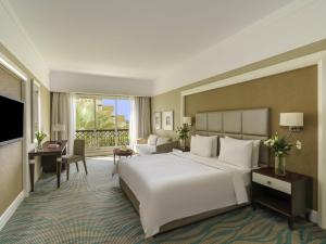 a hotel room with a large bed and a television at Rixos Bab Al Bahr - Ultra All Inclusive in Ras al Khaimah