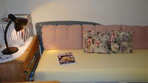 a bed with two pillows and a book on it at Haus König Fewo in Türnitz +30 photos