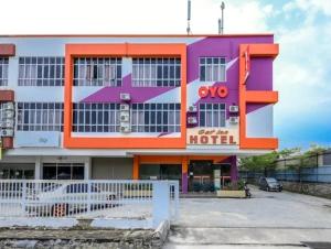 a building with an orange and purple at Get Inn Hotel in Gua Sai