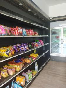 a store shelves filled with different types of food at Get Inn Hotel in Gua Sai
