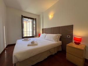 a bedroom with a large bed with two towels on it at Teentori in Camposampiero