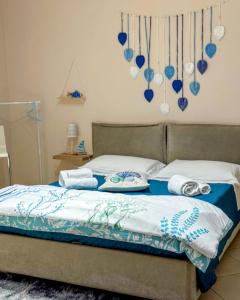 een slaapkamer met een bed met blauwe en witte lakens bij N67 B&B Taranto Centro-3 camere indipendenti in Taranto