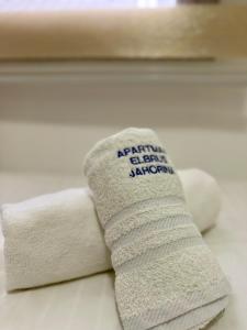 a stack of towels sitting on top of a bed at Ski kuca Elbrus in Jahorina