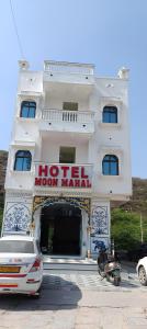 a hotel with a car parked in front of it at Hotel Moon Mahal in Jaipur