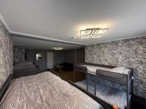 a bedroom with two bunk beds in a room at ADAM Hostel Krāslava in Krāslava