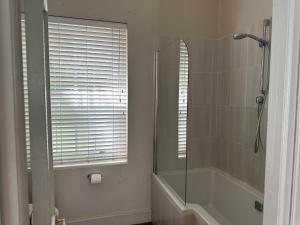 a bathroom with a shower and a tub and a mirror at Le Manse in Franschhoek +19 photos