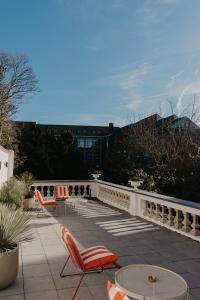 a patio with chairs and a table and a fence at Isidore in Bruges