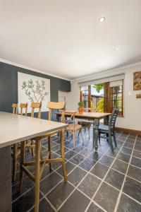 a dining room with wooden tables and chairs at Avemore Time Out Le Verger in Stellenbosch