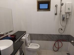 a bathroom with a toilet and a sink and a shower at House in the heart of Kamala in Kamala Beach +16 photos