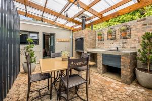 an outdoor kitchen with a table and chairs in a patio at Avemore Time Out Le Verger in Stellenbosch +46 photos