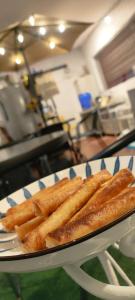a plate of french fries on a table at Thai Nee Homestay in Manila +7 photos