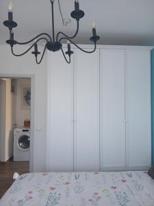 a bedroom with white cabinets and a bed at Casa Aurora Nicole in Pergine Valsugana