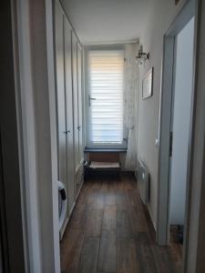 a hallway with a window and a wooden floor at Casa Aurora Nicole in Pergine Valsugana
