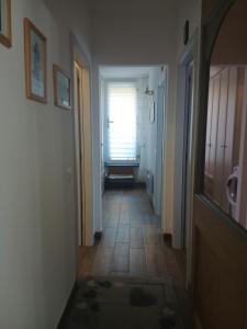a hallway with a door and a window in a room at Casa Aurora Nicole in Pergine Valsugana +14 photos