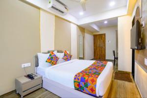 a bedroom with a bed and a television in it at FabHotel Melody NX in Thane +31 photos