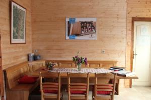 a wooden dining room with a table and chairs at Maison Alsacienne in Nothalten