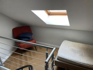 a attic room with a bed and a skylight at Loft industriel - hyper centre cambrai in Salles-sur-Mer
