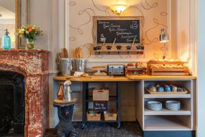a kitchen with a table with a chalkboard at The Originals Boutique, Hôtel Normandie, Auxerre in Auxerre