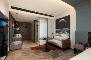 a living room with a couch and a table at Atour S Hotel Beijing International Trade CBD Jianguo Men in Beijing