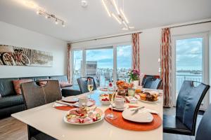 a dining room with a table with food on it at Schleivilla Lootsen Hus by Seeblick Ferien ORO, 3Etagen,8Pers,Sauna,Kamin in Olpenitz +31 photos