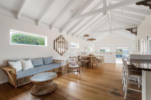 a living room with a couch and a table at Saltwood Walk to Yallingup Lagoon in Yallingup