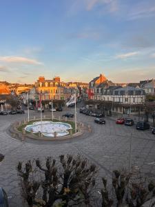 a city with a fountain in the middle of a parking lot at Hyper Centre DEAUVILLE 3 chambres in Deauville