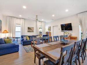 a living room with a table and a blue couch at Lime Time in Tybee Island