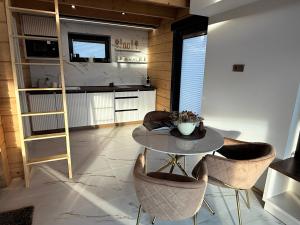 a room with a table and chairs and a kitchen at Bükk Hill Garden in Miskolc