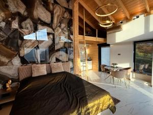 a bedroom with a large stone wall and a bed at Bükk Hill Garden in Miskolc