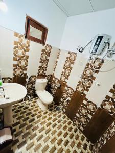 a bathroom with a toilet and a sink at Palitha Homestay in Sigiriya