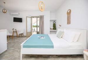 a white bedroom with a large bed in a room at Eleonas 2 in Maragkas