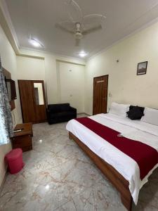 a bedroom with a large bed and a couch at Hotel Moon Mahal in Jaipur