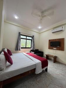a bedroom with a large bed and a television at Hotel Moon Mahal in Jaipur
