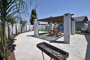 a picnic table and a bench on a patio at אחוזת אודליה במושב דלתון in Shahar