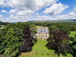 an aerial view of an old house with trees at Stow House in Aysgarth